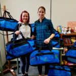 Nicole McCoy and Vicky Fairhurst prepare sweet cases for Just Right Project donation to Adopt KC Kids