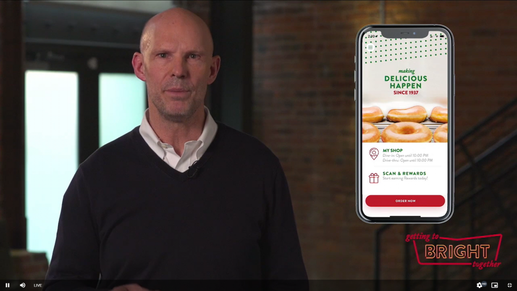 Presenter next to image of Krispy Kreme app