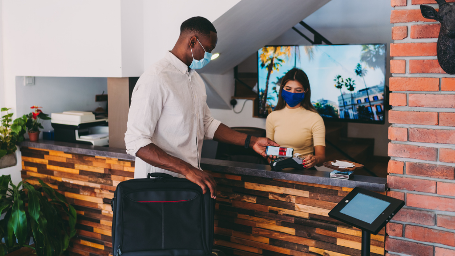man using contactless check-in for COVID protocol