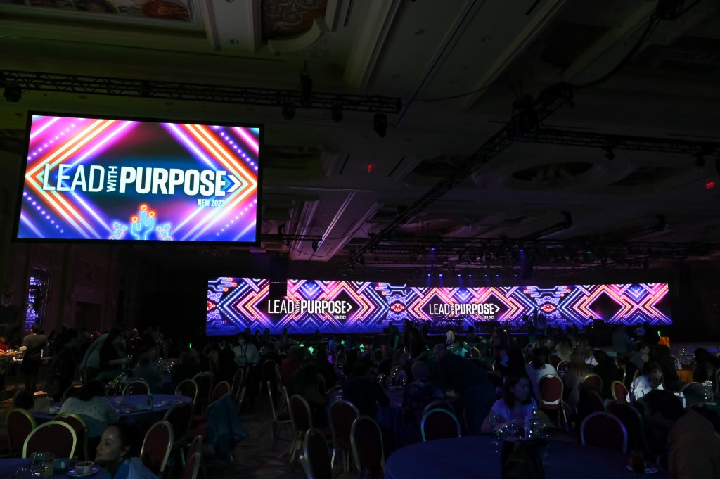 "Lead with Purpose" stage signage