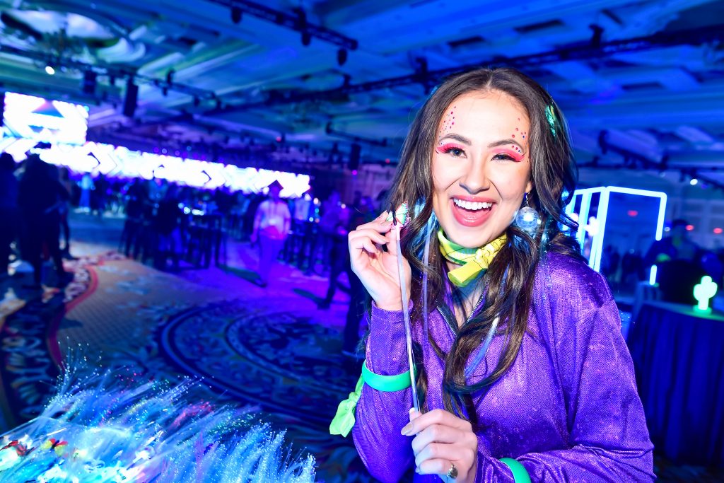 attendee smiling in neon disco attire