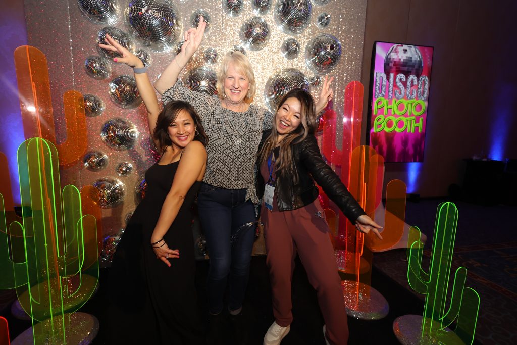 attendees posing in photo booth