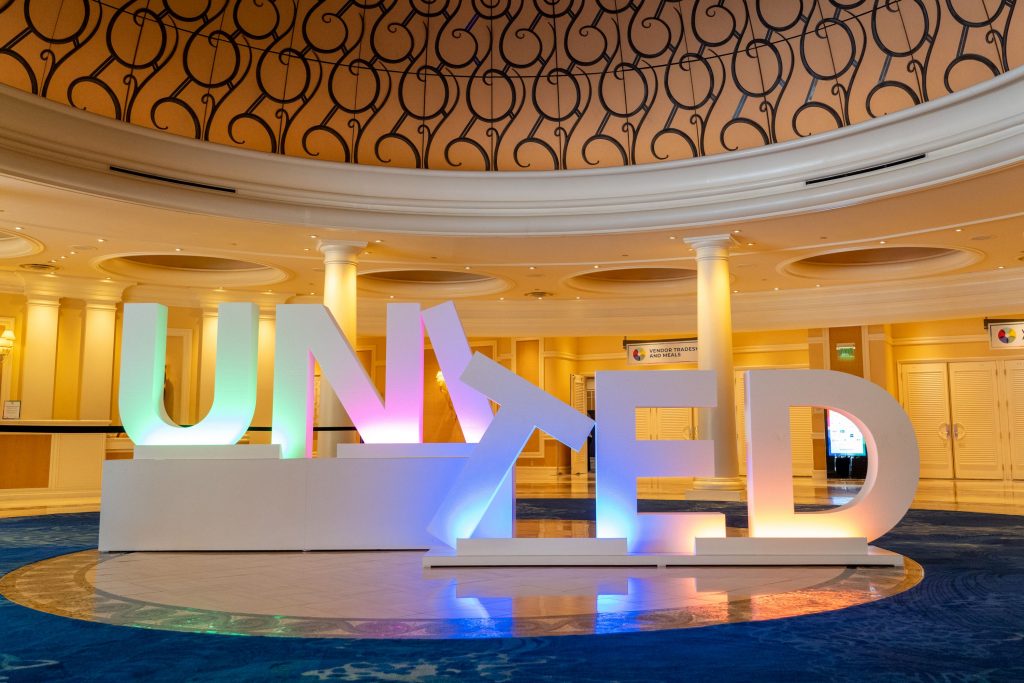 large "UNITED" sign at franchise conference