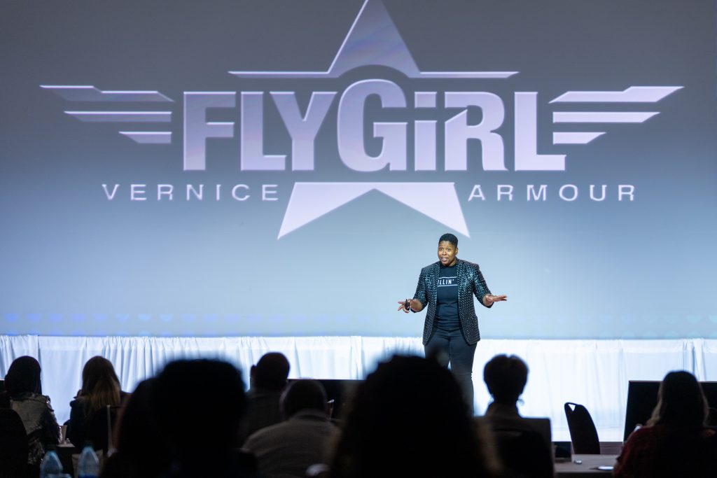 Vernice "FlyGirl" Armour on stage at franchise conference