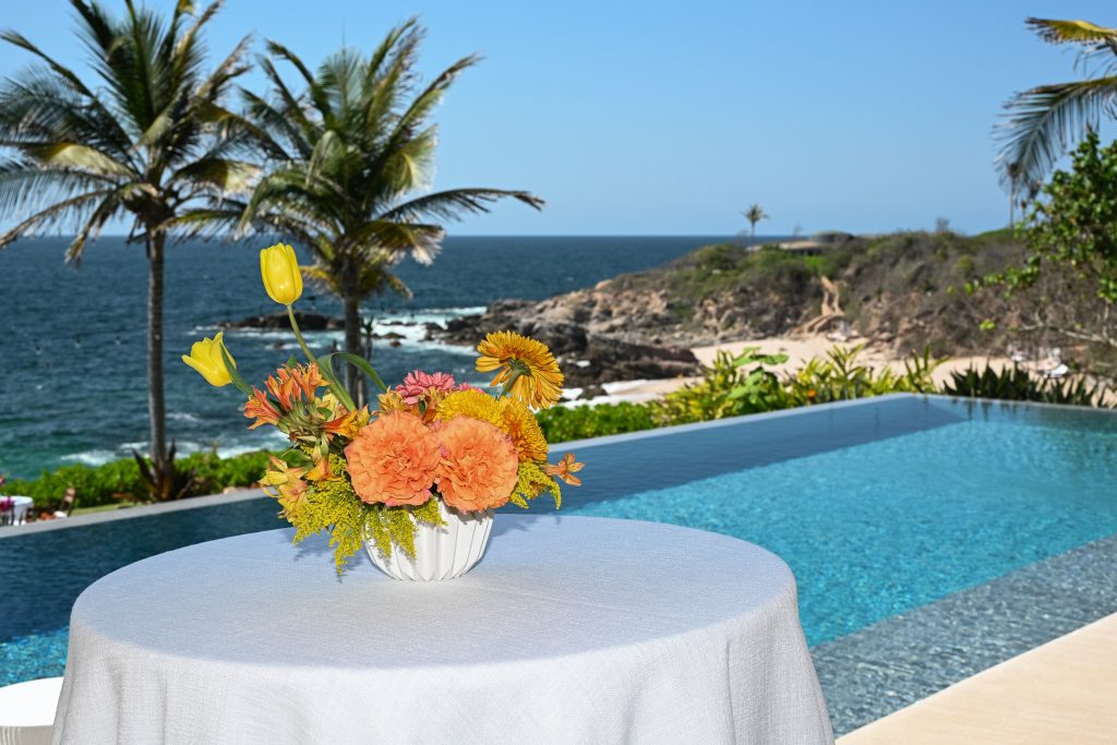 table by the pool overlooking the ocean