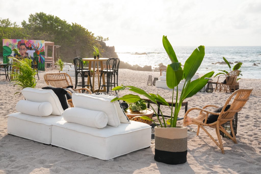 lounge area on beach facing mural