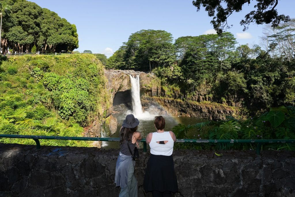attendees facing waterfall 