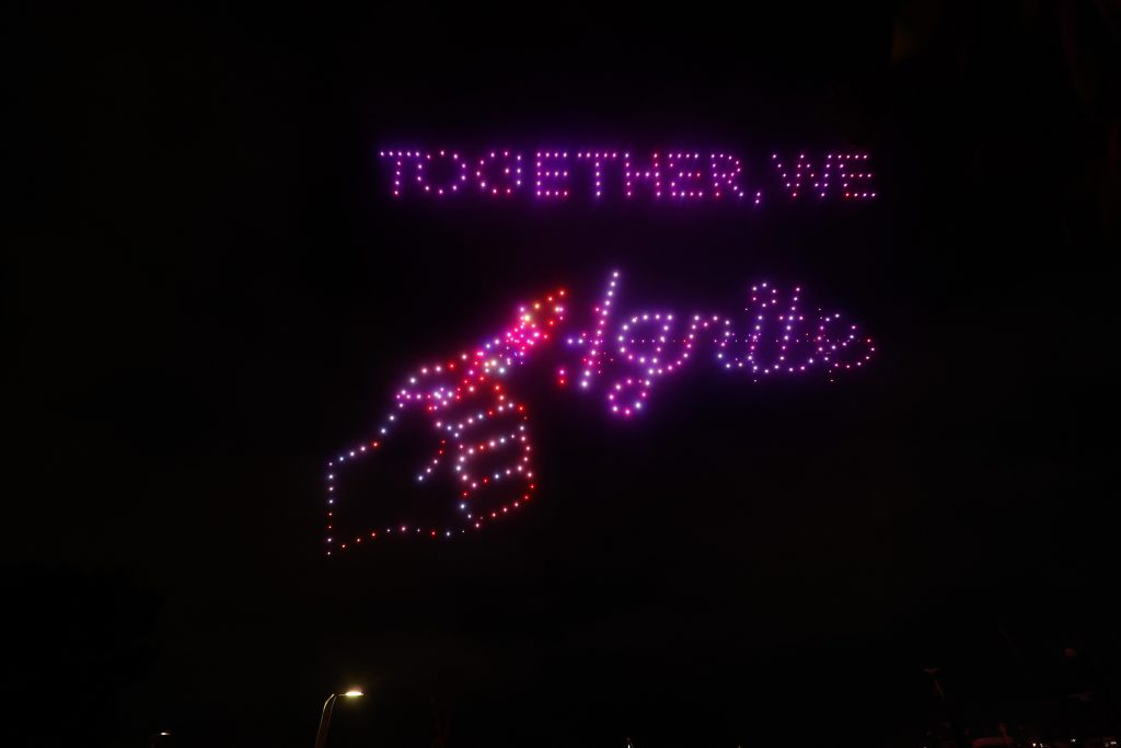 "Together, We Ignite" written in drones
