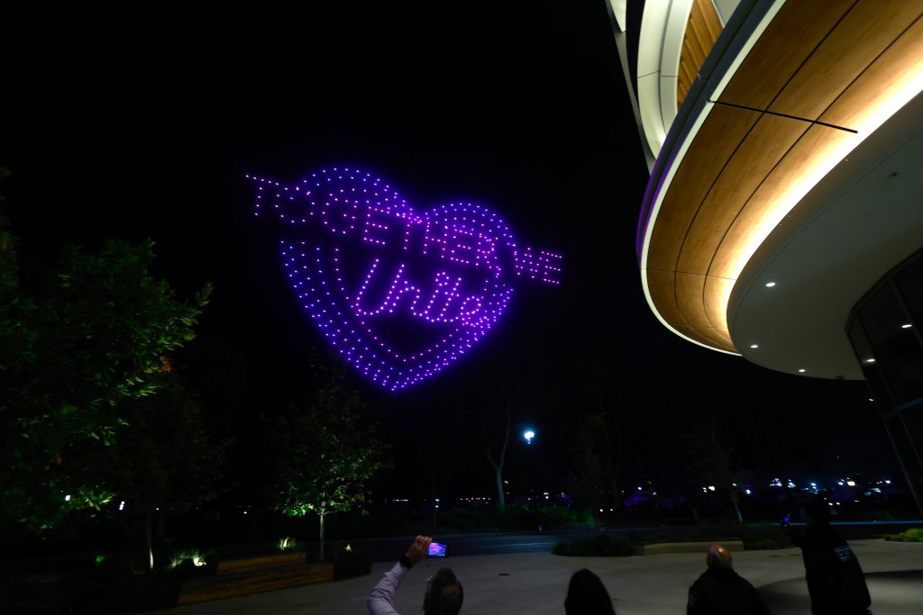 drones forming the words "Together, We Unite" in a heart