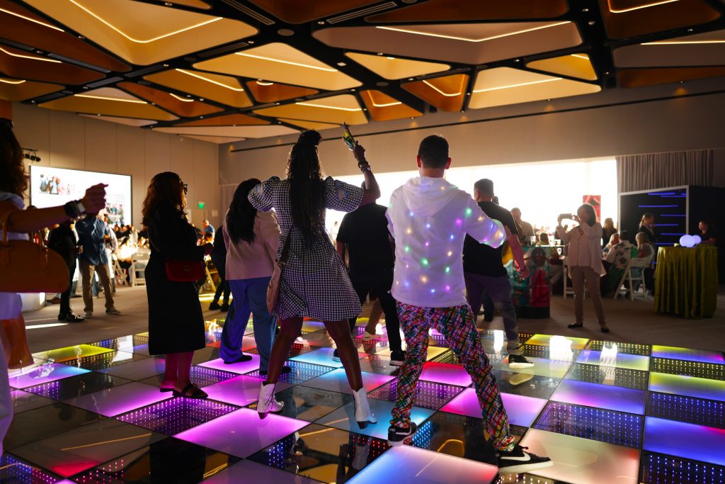 attendees dancing on light-up dance floor