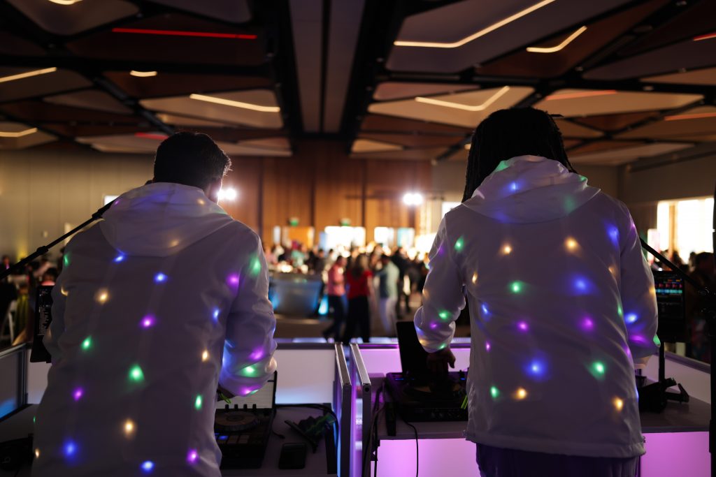 glowing jackets on dueling DJs