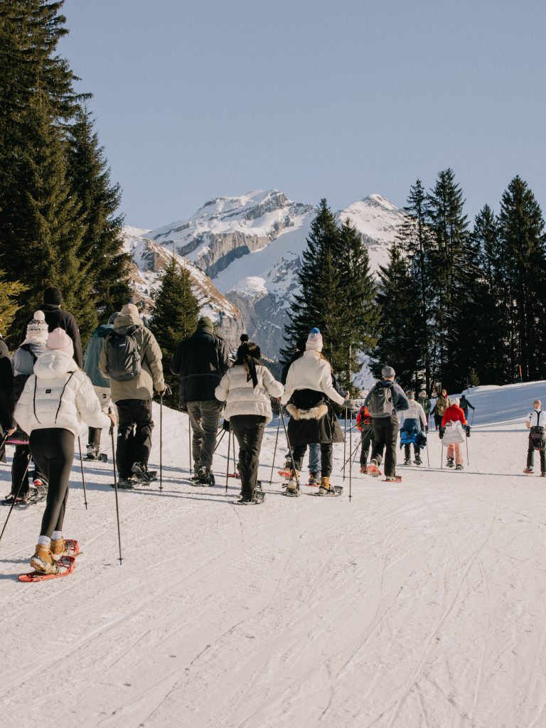 attendees snowshoeing in the mountains