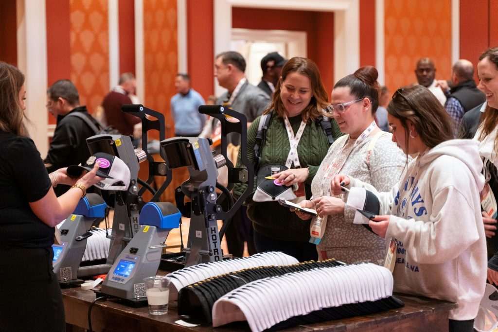 attendees getting hats customized at event