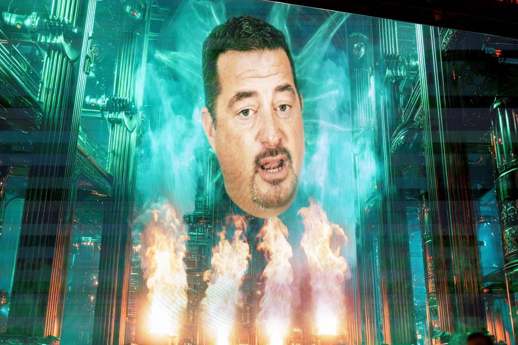 executive on screen as the "Wizard" from Wizard of Oz