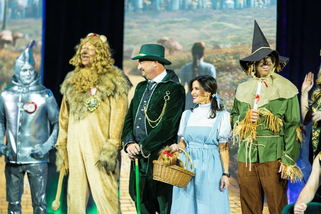 executives on stage as characters from the Wizard of Oz