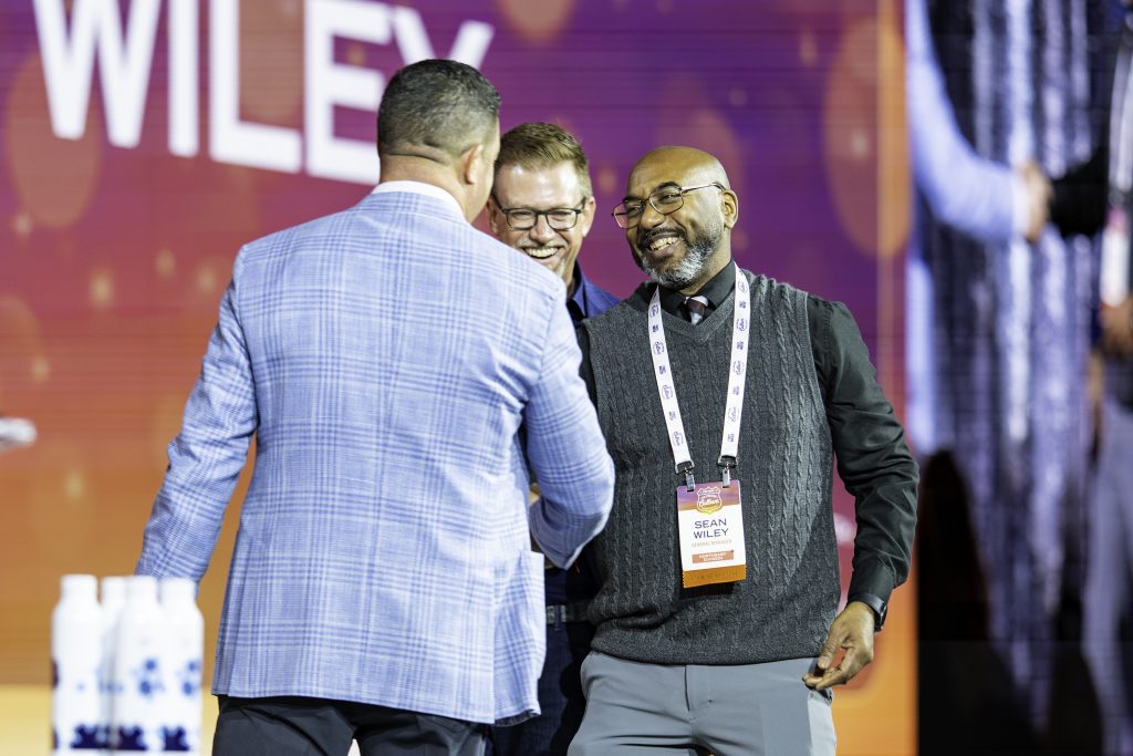 award winner smiling on stage