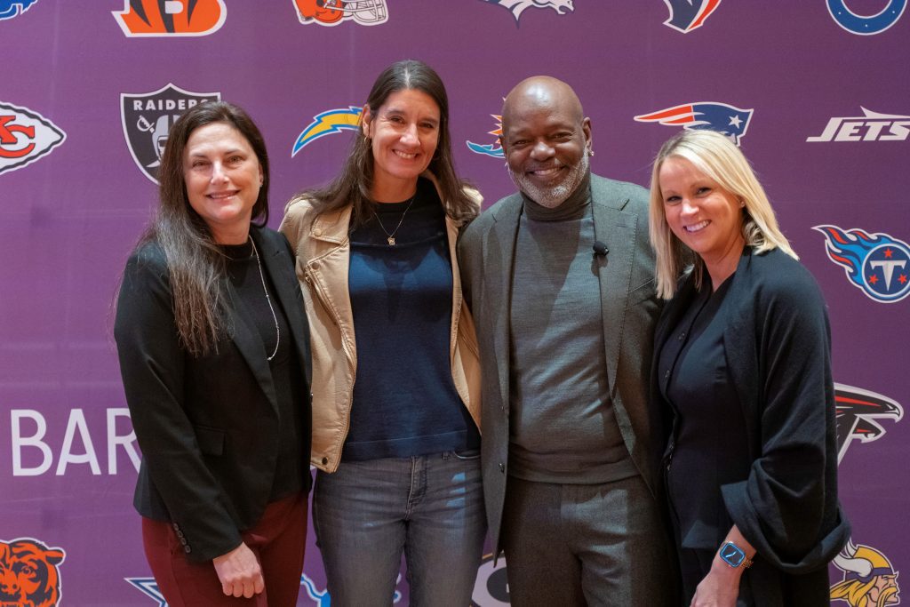 attendees smiling with Emmitt Smith