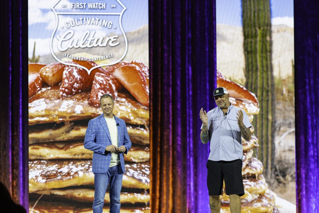 speakers on stage at corporate leadership conference