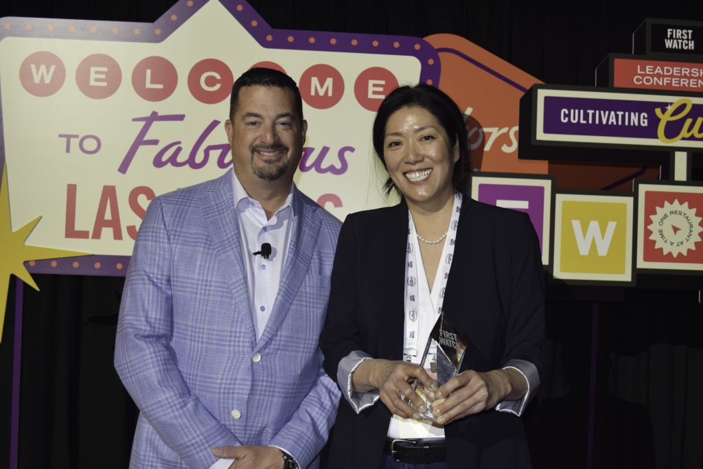 award winner smiling with award