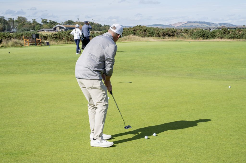 attendee playing golf at St. Andrews